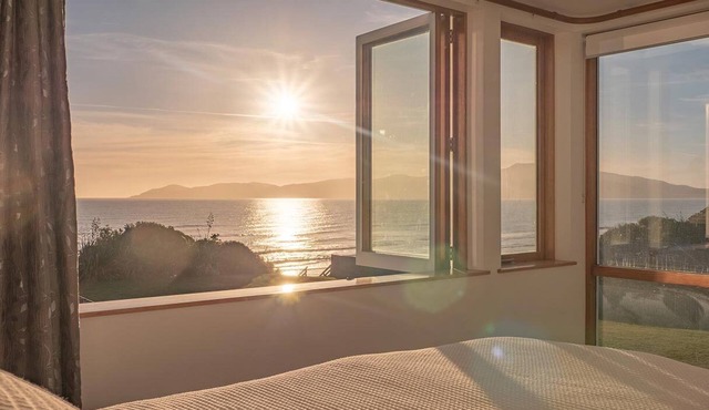 Absolute beachfront home with stunning views in Raumati. Sleeps up to 18 people.