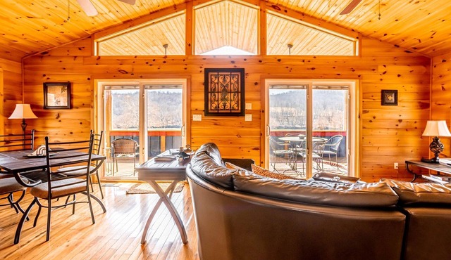 Charming riverside with stunning views, cozy interiors, full amenities, and spacious decks.