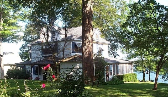 Gorgeous Sandy Beachfront Paw Paw lake home with 155 ft. of frontage and dock